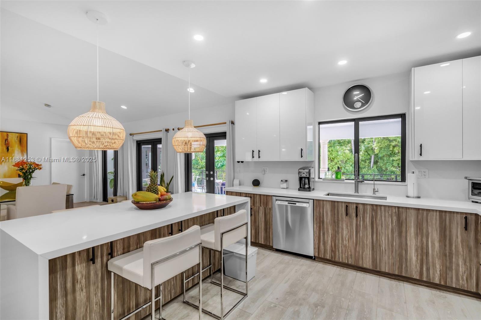 340 Woodcrest Road Key Biscayne, FL 33149 - Photo 13 of 51 a kitchen with a table chairs and a window