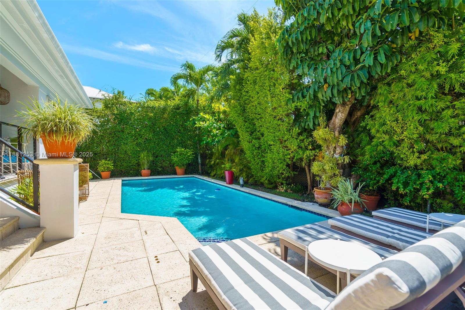340 Woodcrest Road Key Biscayne, FL 33149 - Photo 15 of 51 a view of a patio with table and chairs with wooden floor and fence