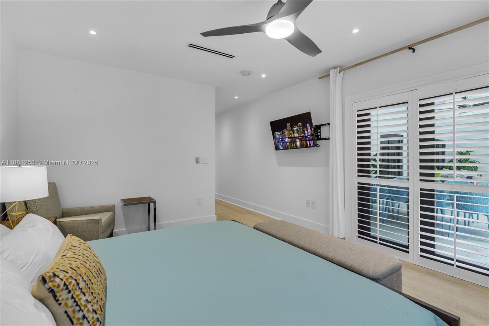 340 Woodcrest Road Key Biscayne, FL 33149 - Photo 17 of 51 a bedroom with a large bed and a chandelier