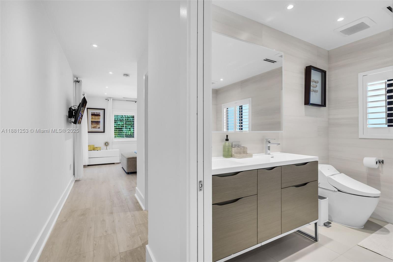 340 Woodcrest Road Key Biscayne, FL 33149 - Photo 19 of 51 a bathroom with a sink a toilet and mirror