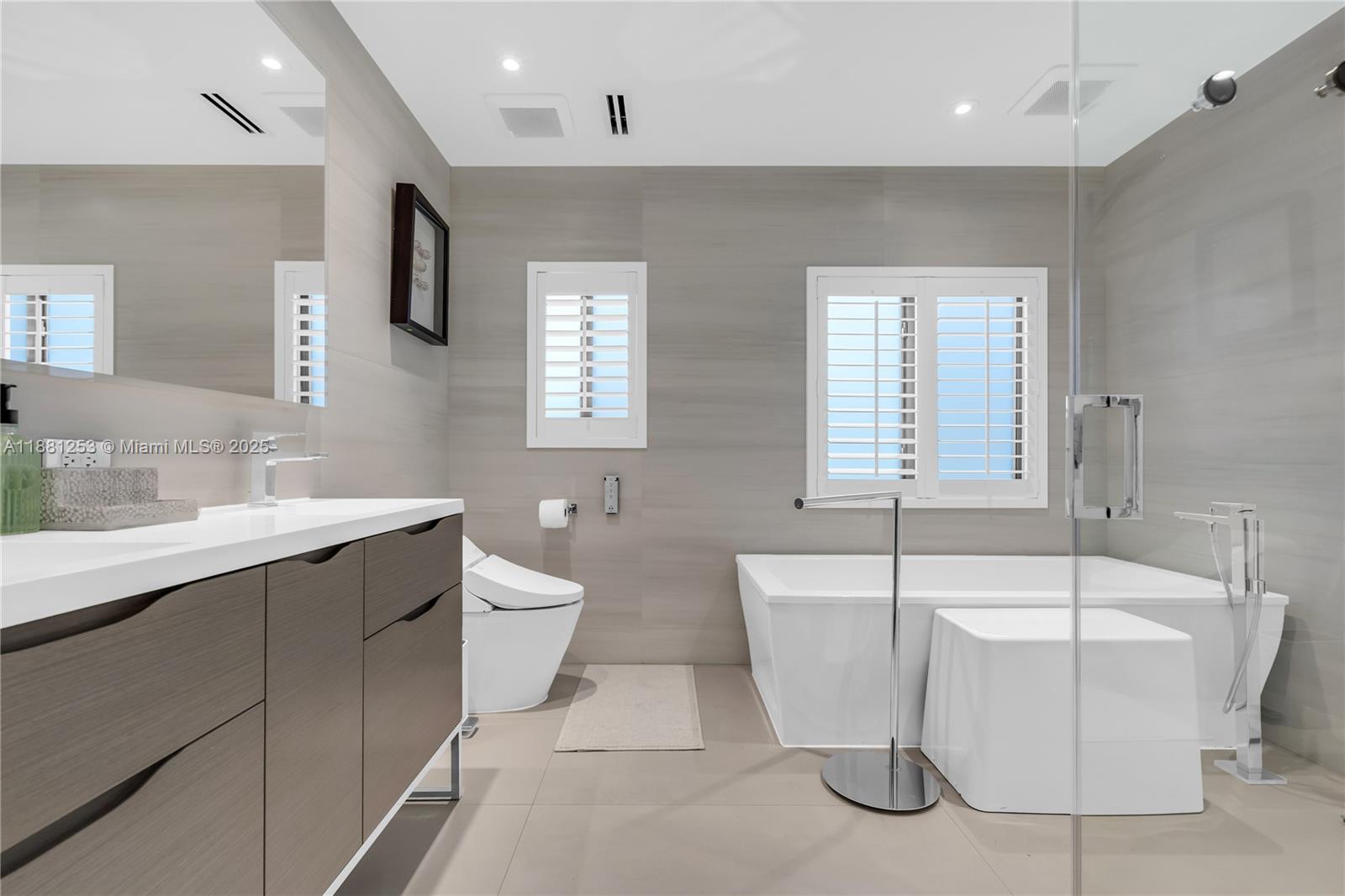 340 Woodcrest Road Key Biscayne, FL 33149 - Photo 20 of 51 a spacious bathroom with a double vanity sink mirror and bathtub