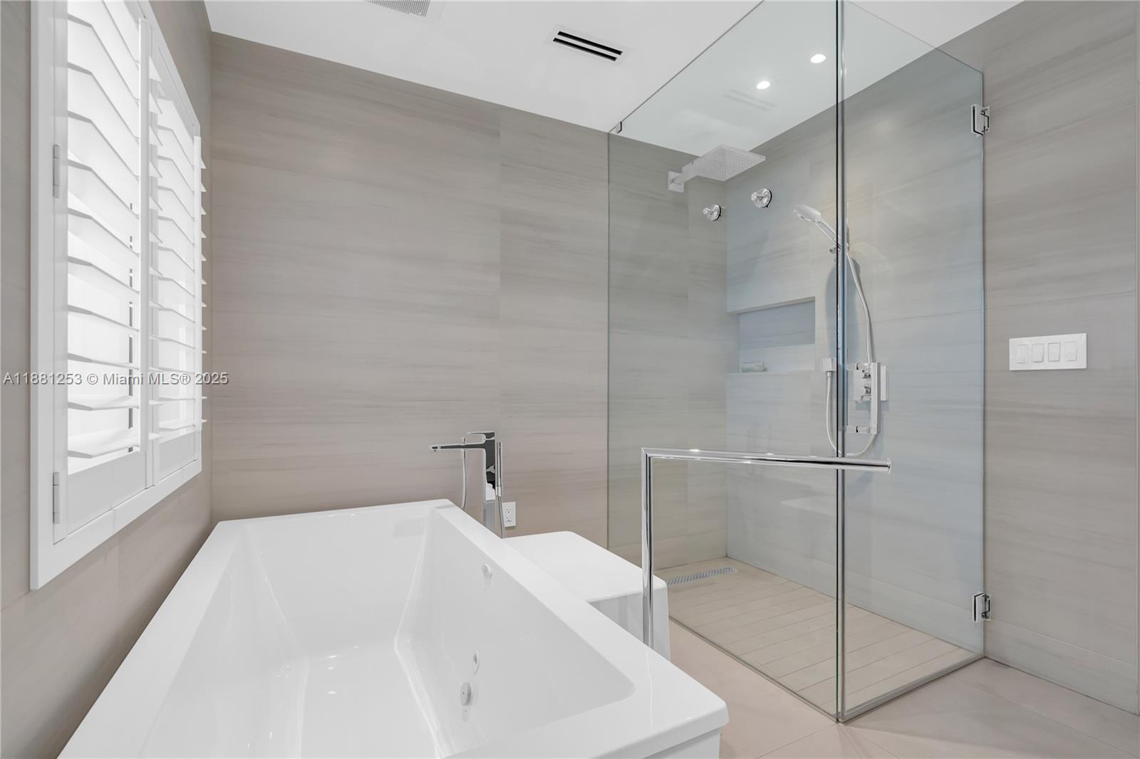 340 Woodcrest Road Key Biscayne, FL 33149 - Photo 21 of 51 a bathroom with a bathtub and a shower
