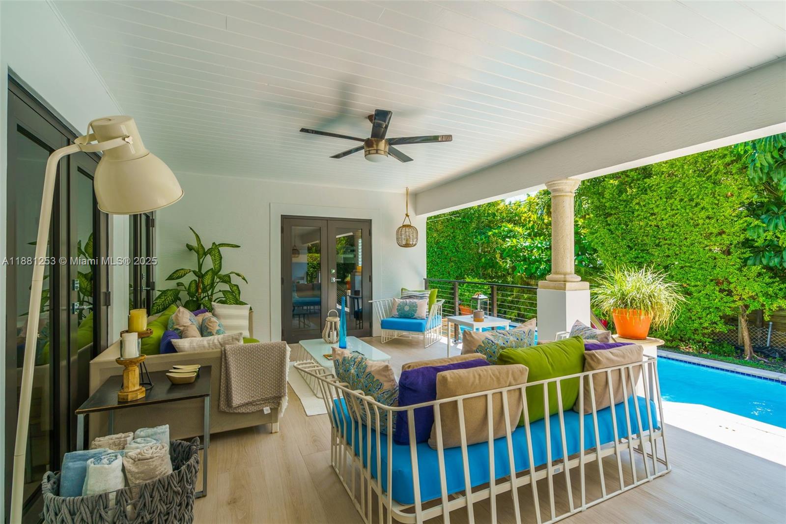 340 Woodcrest Road Key Biscayne, FL 33149 - Photo 25 of 51 a living room with furniture a lamp and a large window