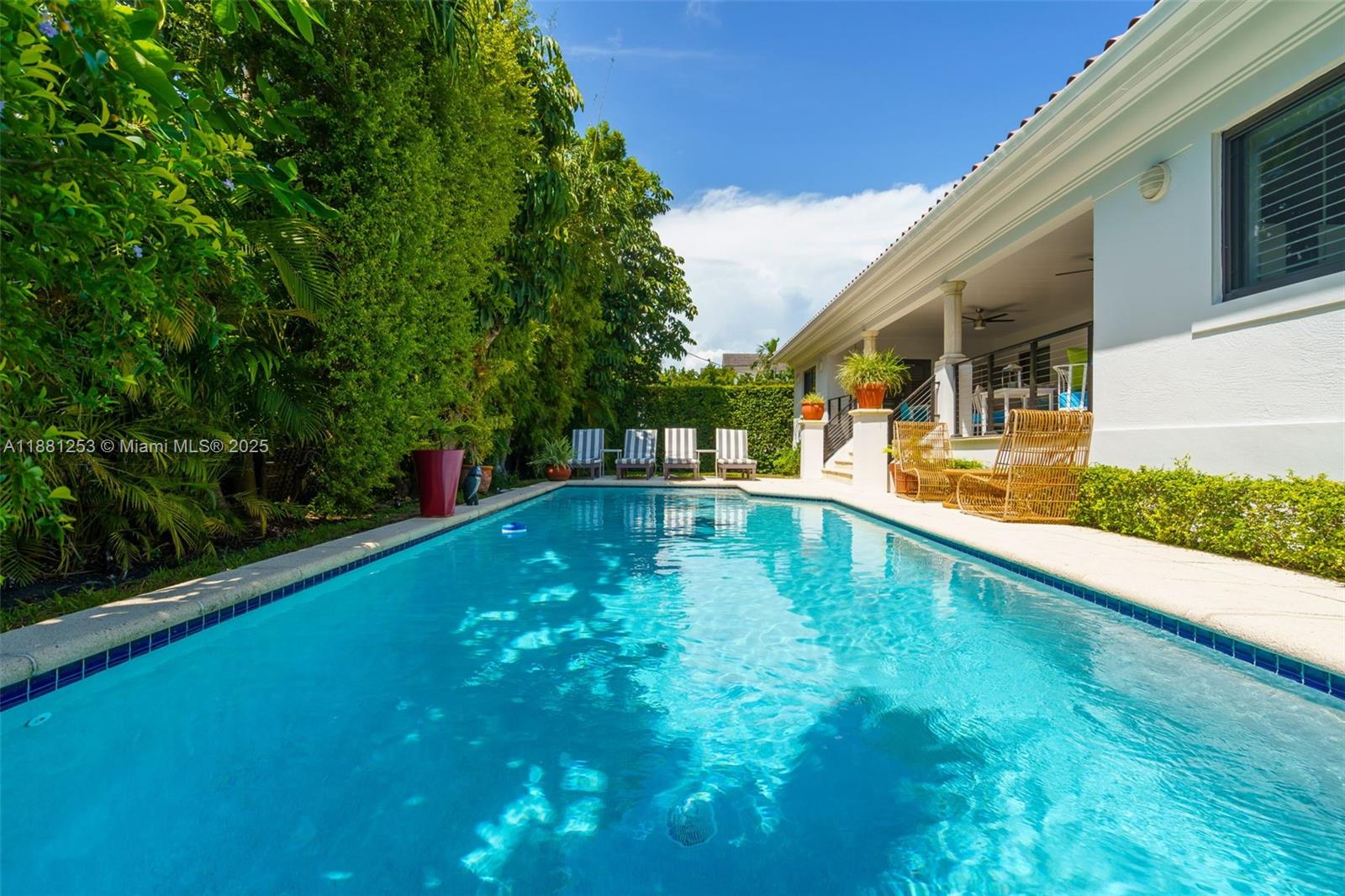 340 Woodcrest Road Key Biscayne, FL 33149 - Photo 27 of 51 a swimming pool with outdoor seating and yard