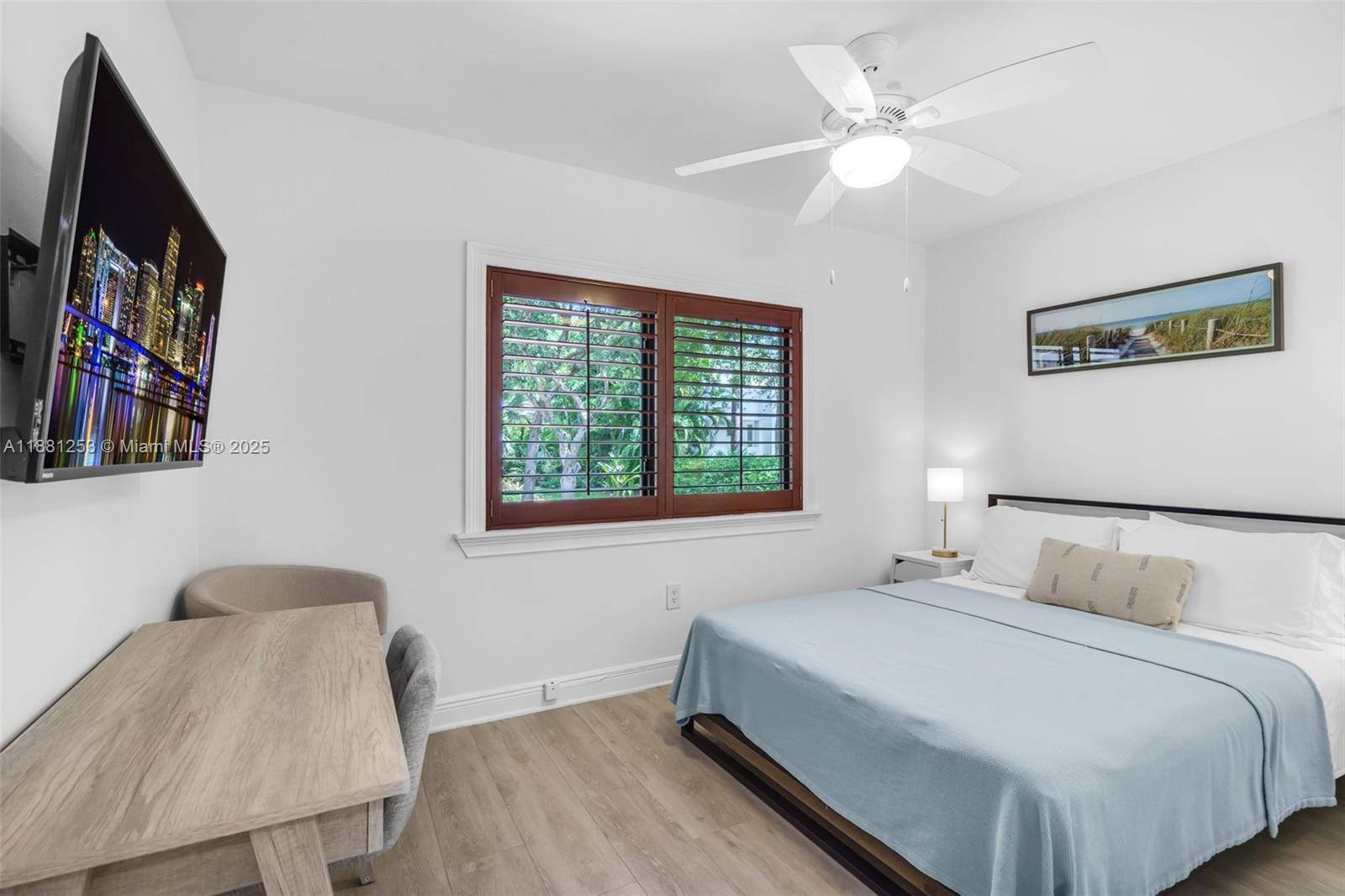 340 Woodcrest Road Key Biscayne, FL 33149 - Photo 28 of 51 a bedroom with a large bed and a chandelier