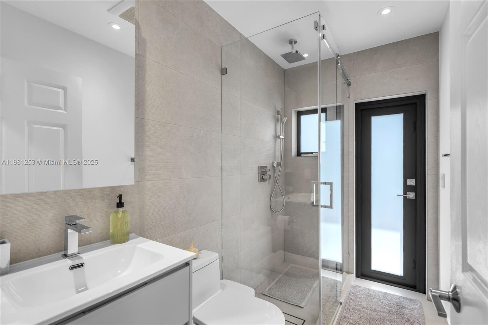 340 Woodcrest Road Key Biscayne, FL 33149 - Photo 30 of 51 a bathroom with a sink toilet vanity and shower