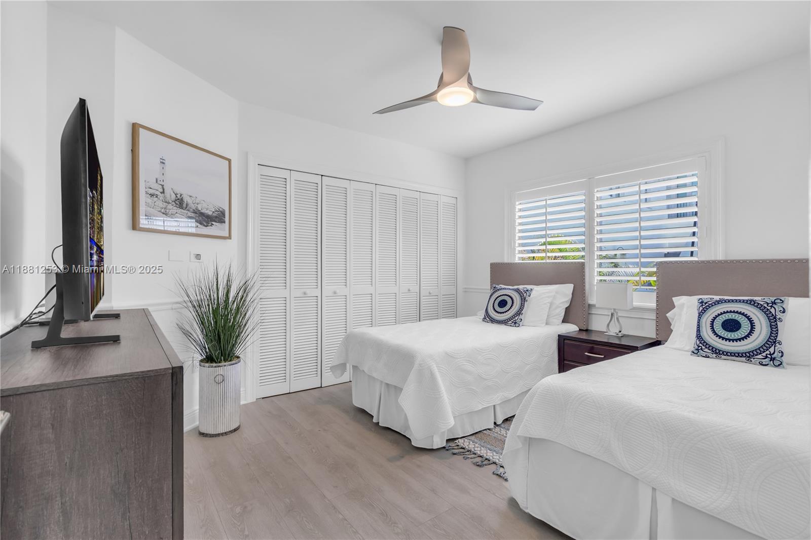 340 Woodcrest Road Key Biscayne, FL 33149 - Photo 34 of 51 a bedroom with two beds and a chandelier