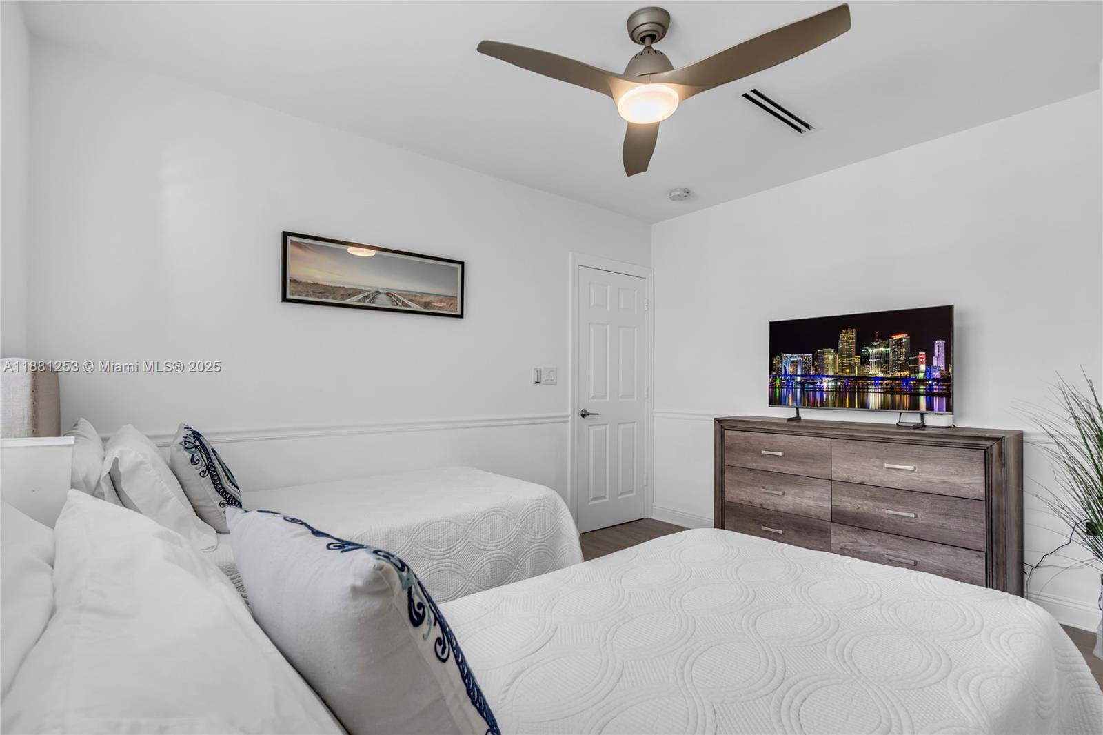 340 Woodcrest Road Key Biscayne, FL 33149 - Photo 35 of 51 a bedroom with a bed and a dresser