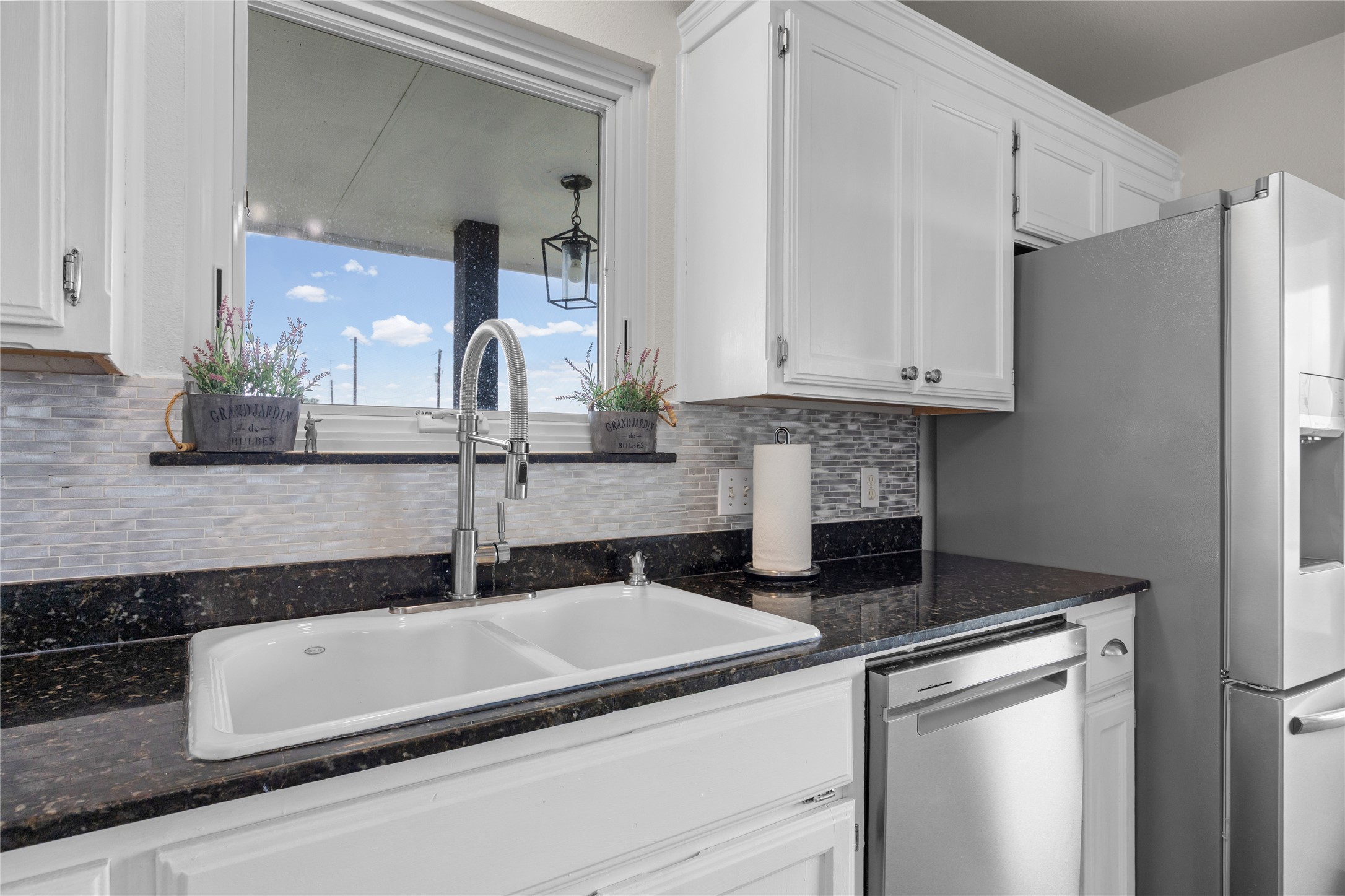1283 Rattlesnake Trail Burnet, TX 78611 - Photo 21 of 39 a kitchen with a sink and a refrigerator