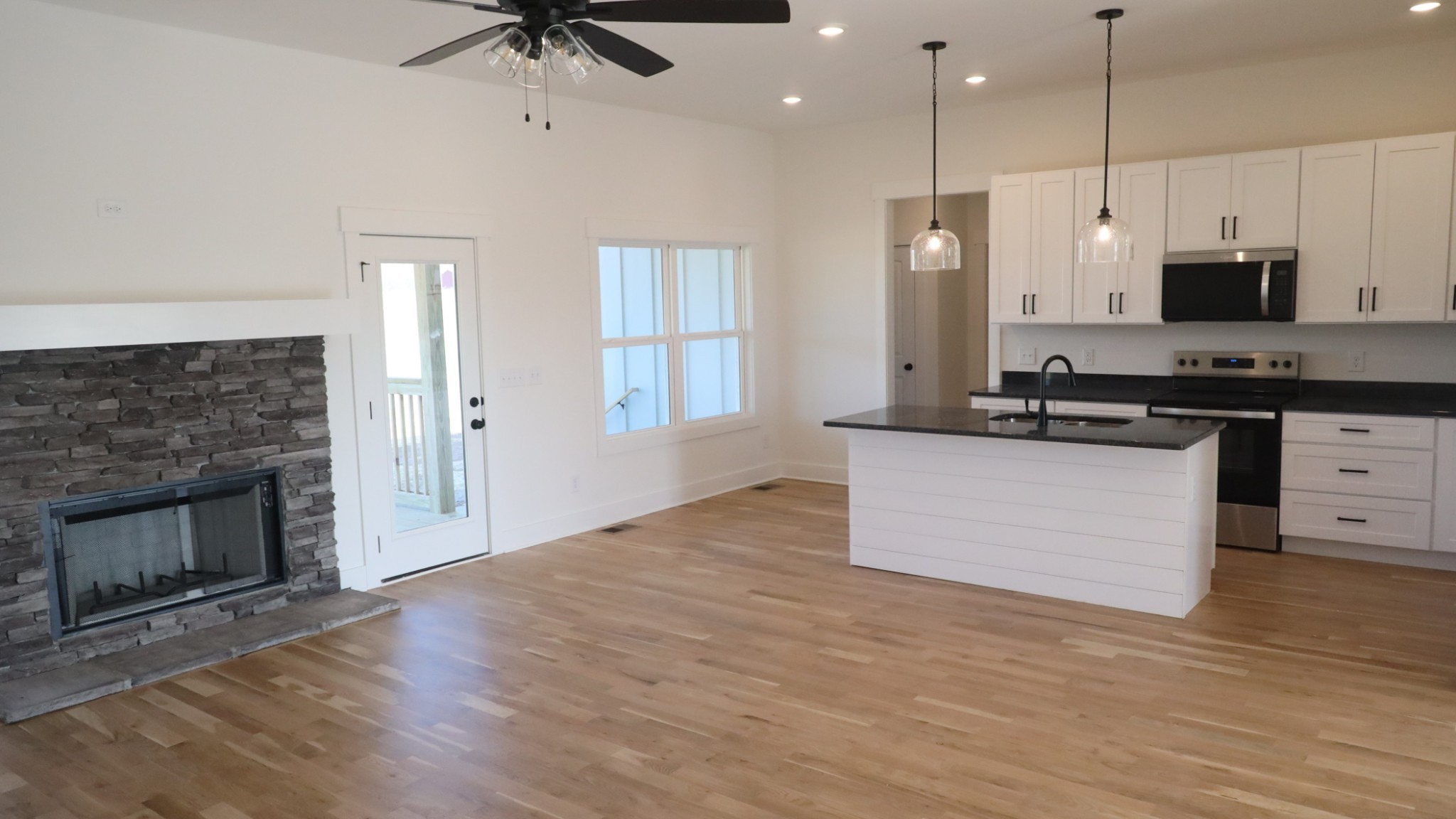 5558 Borthick Road Springfield, TN 37172 - Photo 12 of 53 a kitchen with stainless steel appliances a stove top oven a sink and a fireplace