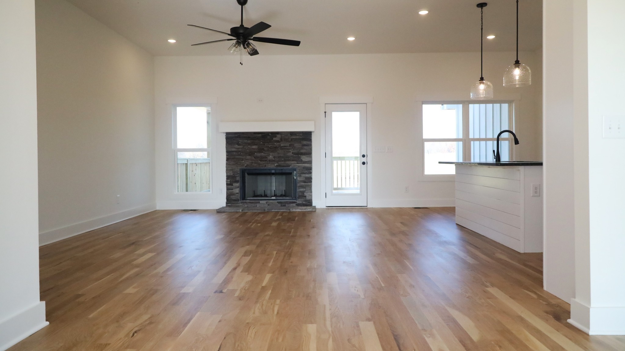 5558 Borthick Road Springfield, TN 37172 - Photo 13 of 53 an empty room with wooden floor fireplace and windows