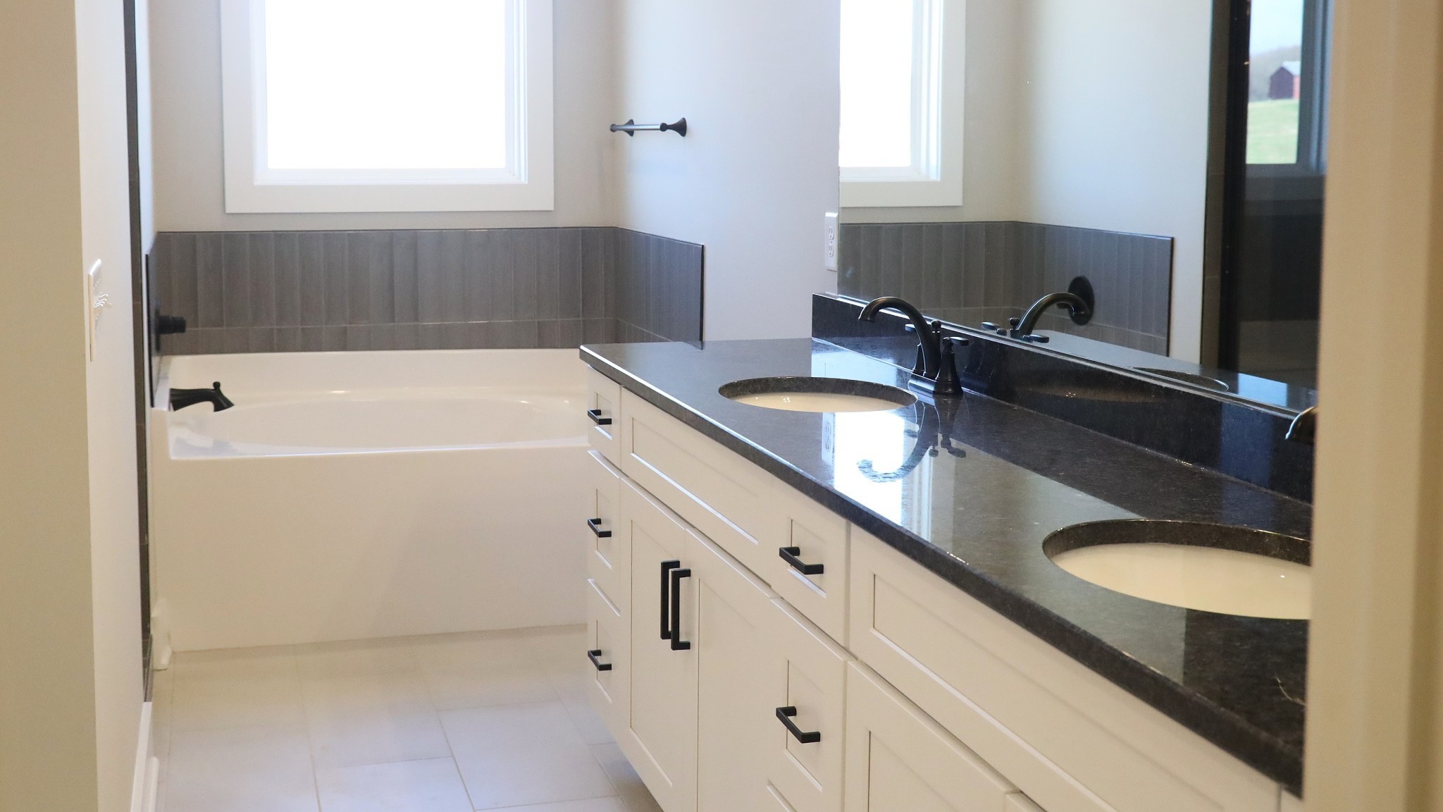 5558 Borthick Road Springfield, TN 37172 - Photo 18 of 53 a bathroom with a granite countertop sink and mirror with bathtub