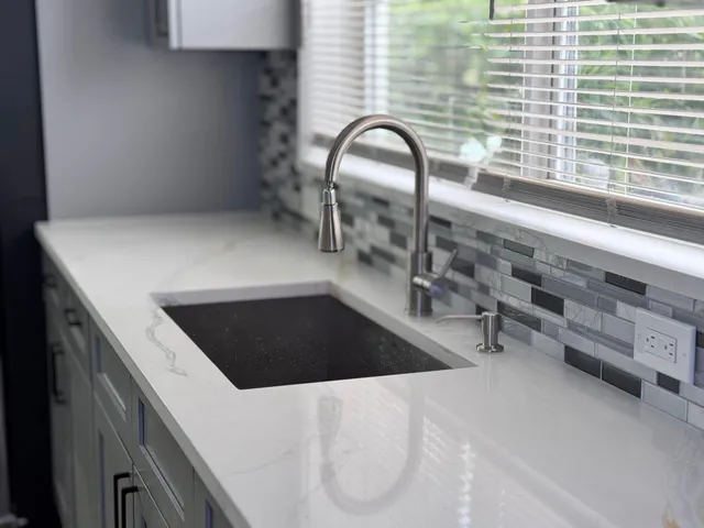 a view of a kitchen counter top a sink and dishwasher