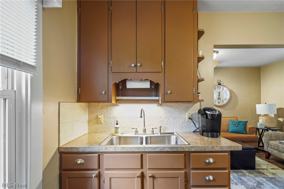 629 Clinton Street Niles, OH 44446 - Photo 4 of 50 Kitchen featuring a double basin stainless steel sink with a chrome faucet, under-cabinet lighting, and a neutral-toned countertop