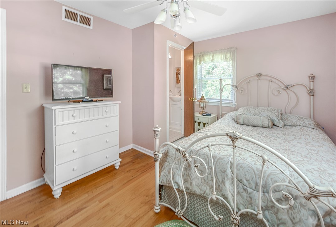 446 Stratford Road Akron, OH 44333 - Photo 16 of 29 Hardwood floored bedroom with ceiling fan, Ensuite private bath and multiple windows
