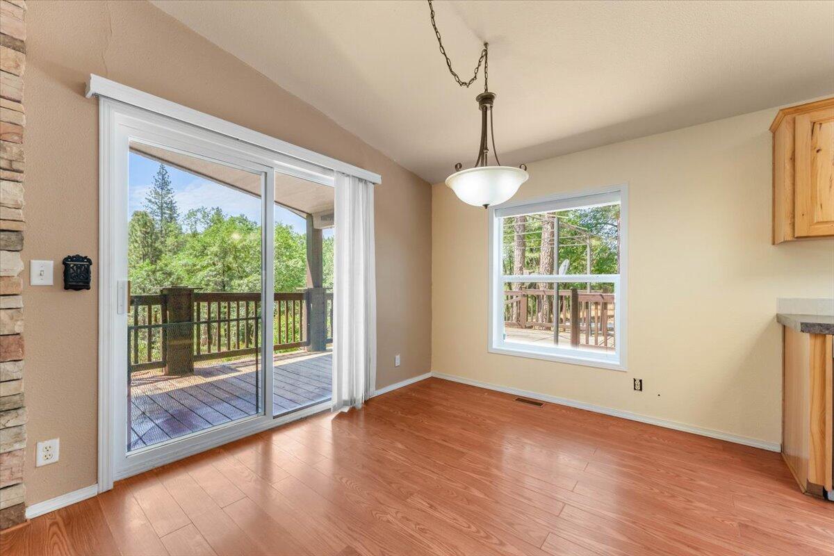 15288 Sherwood Forrest Road Oak Run, CA 96069 - Photo 11 of 91 a view of an empty room with wooden floor and a window