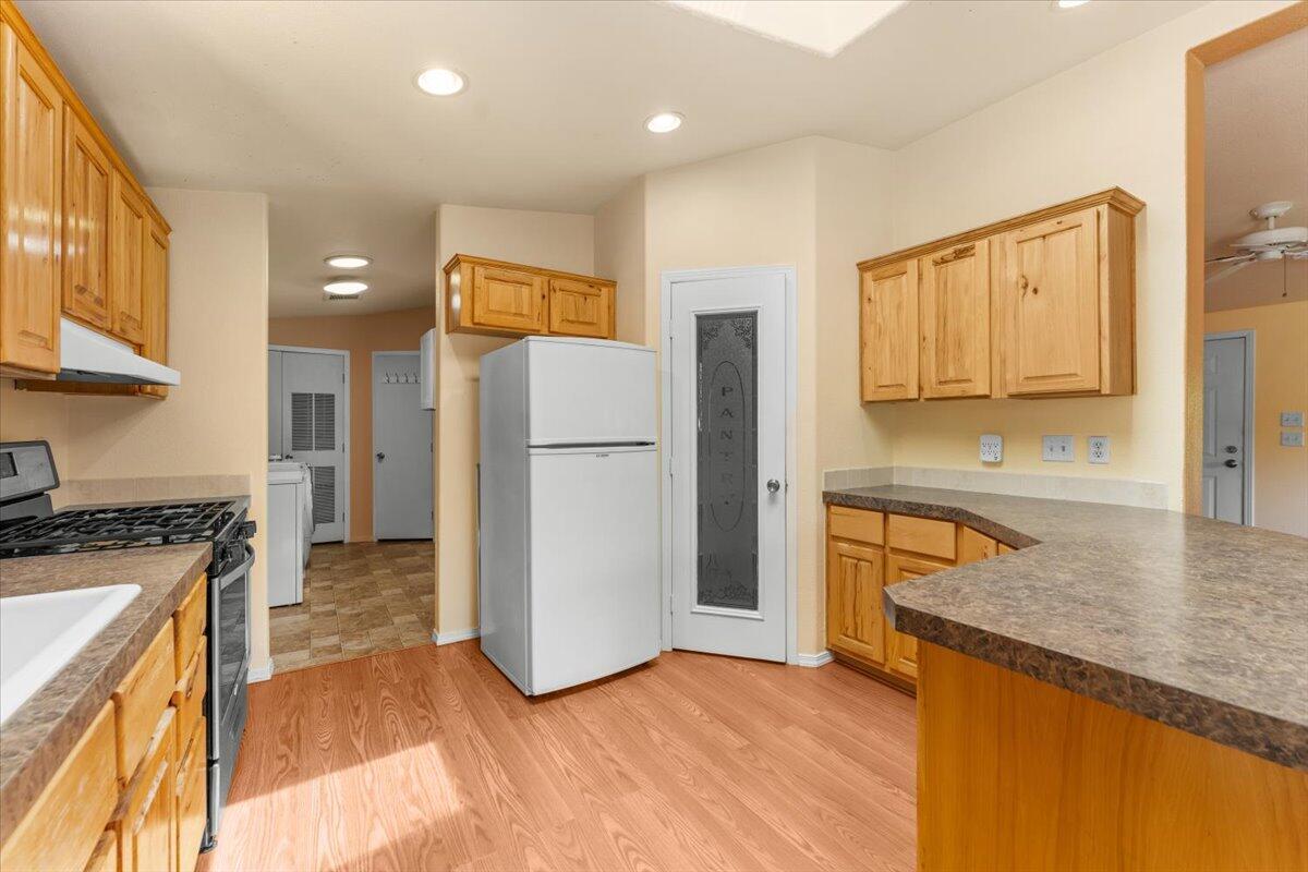 15288 Sherwood Forrest Road Oak Run, CA 96069 - Photo 13 of 91 a kitchen with a refrigerator a stove top oven a sink and dishwasher