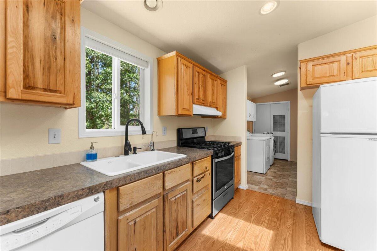 15288 Sherwood Forrest Road Oak Run, CA 96069 - Photo 14 of 91 a kitchen with a sink stove and refrigerator