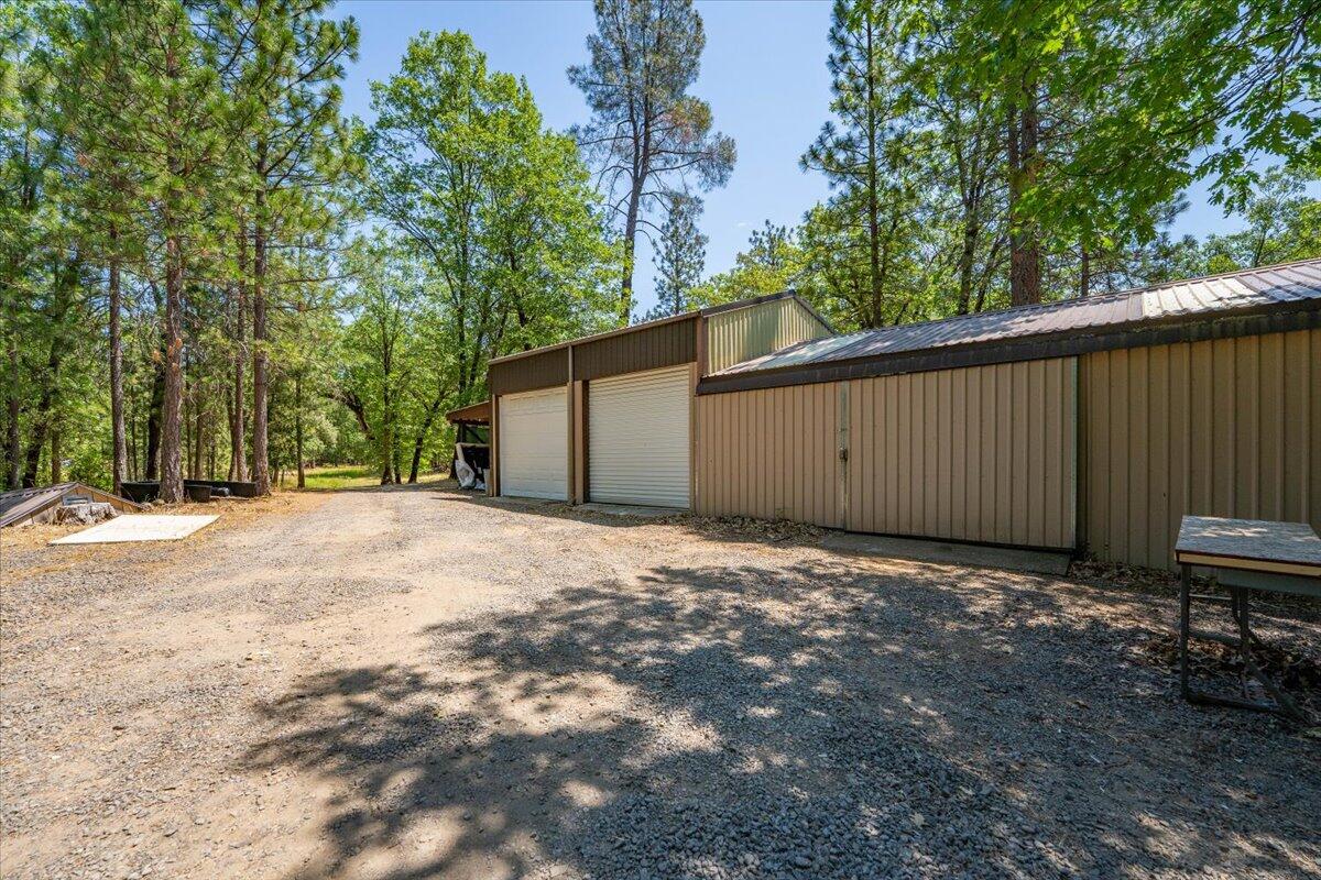15288 Sherwood Forrest Road Oak Run, CA 96069 - Photo 2 of 91 a backyard of a house with table and chairs
