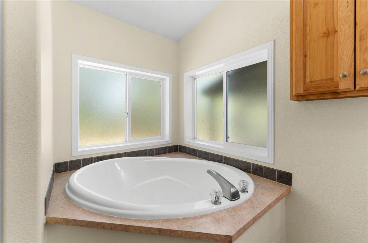 15288 Sherwood Forrest Road Oak Run, CA 96069 - Photo 24 of 91 a bath tub sitting in a bathroom next to a window