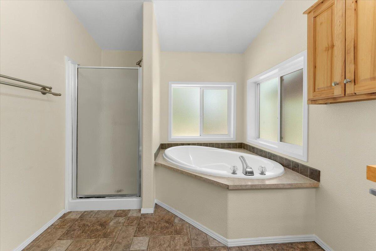 15288 Sherwood Forrest Road Oak Run, CA 96069 - Photo 25 of 91 a bathroom with a tub and shower