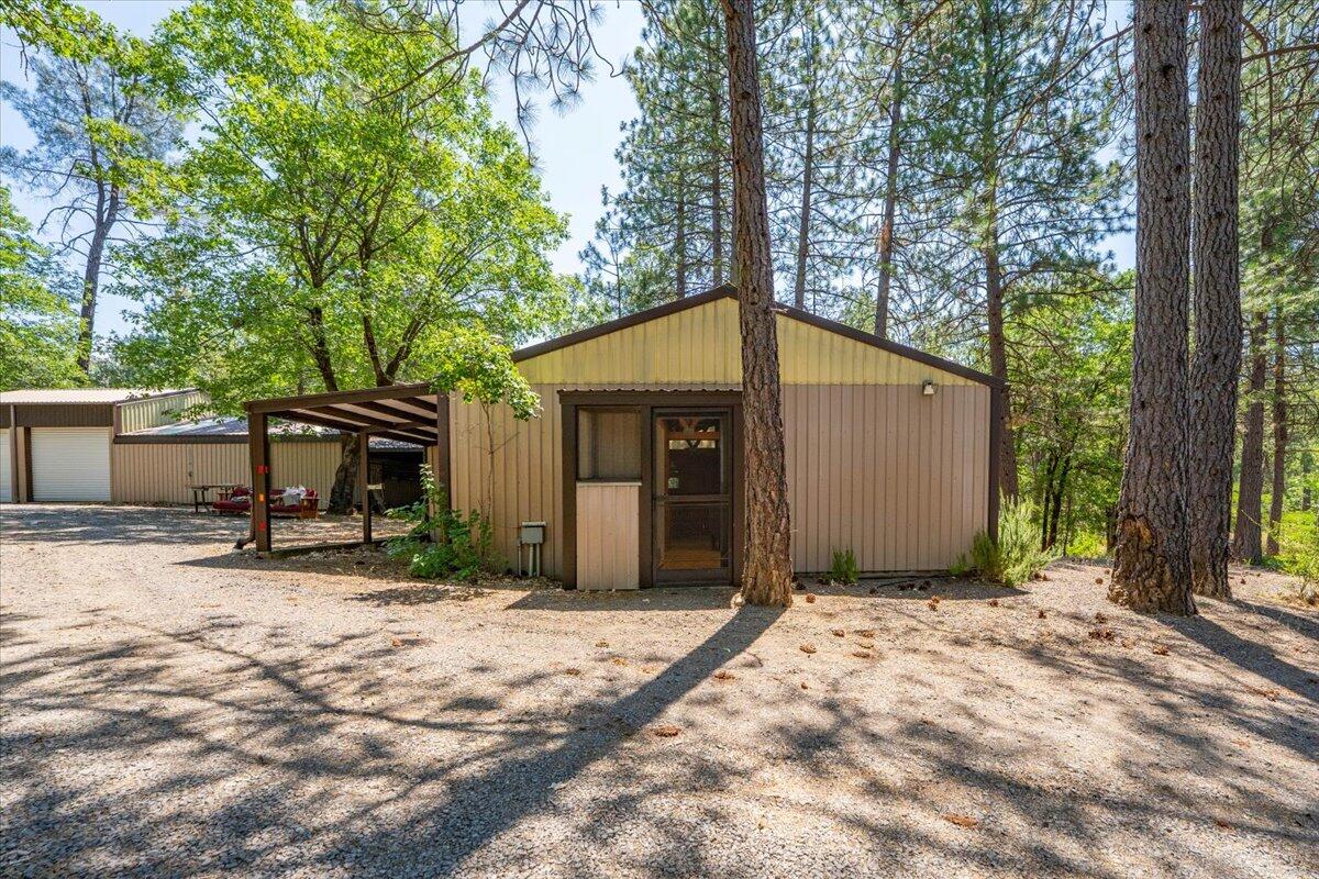 15288 Sherwood Forrest Road Oak Run, CA 96069 - Photo 27 of 91 a backyard of a house with barbeque oven and outdoor seating