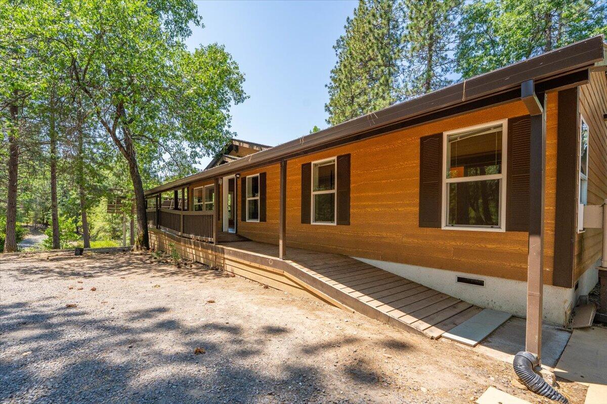 15288 Sherwood Forrest Road Oak Run, CA 96069 - Photo 5 of 91 a front view of a house with a yard