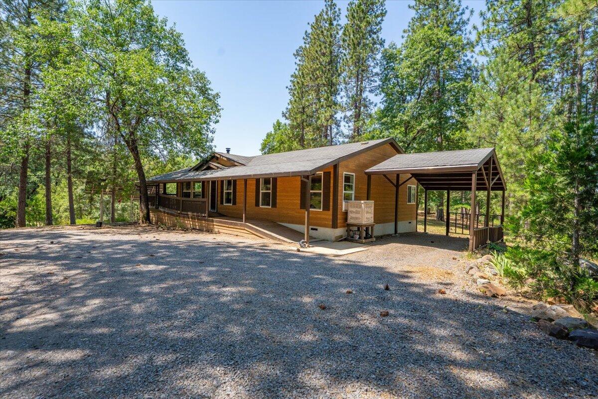 15288 Sherwood Forrest Road Oak Run, CA 96069 - Photo 52 of 91 a front view of a house with garden