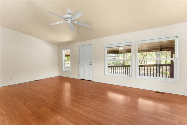wooden floor in an empty room with a window