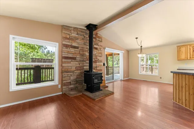 a kitchen with stainless steel appliances granite countertop a refrigerator and a stove top oven