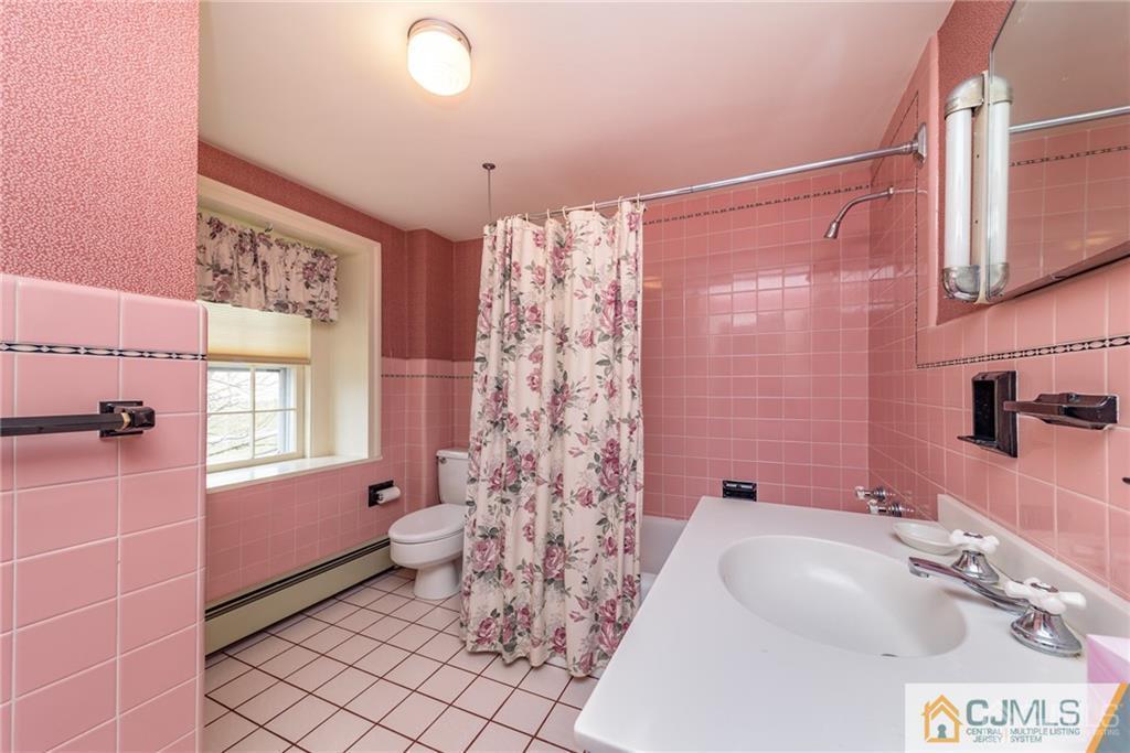 78 Yard Road Stockton, NJ 08559 - Photo 20 of 25 a bathroom with a granite countertop sink a toilet a mirror a vanity and shower