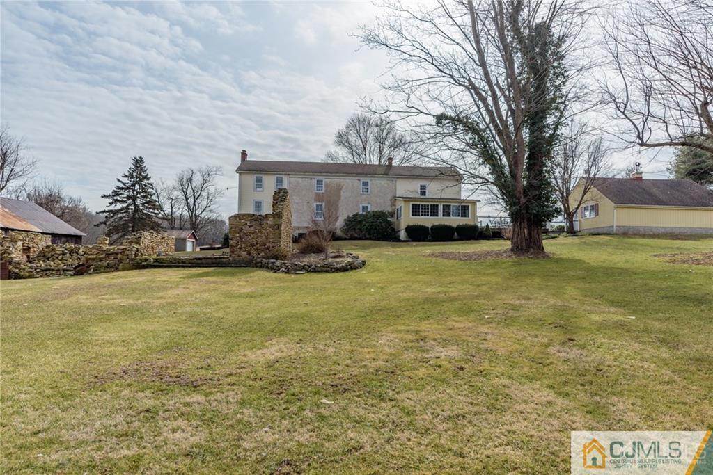 78 Yard Road Stockton, NJ 08559 - Photo 22 of 25 a front view of house with yard and trees in the background