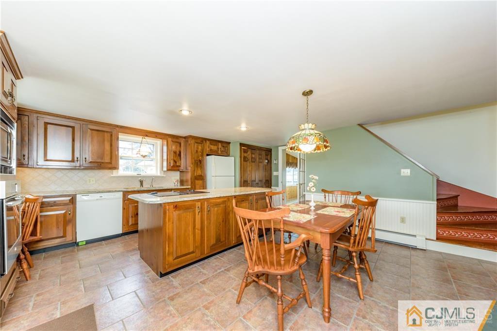 78 Yard Road Stockton, NJ 08559 - Photo 4 of 25 a dining room with a stove a table and chairs