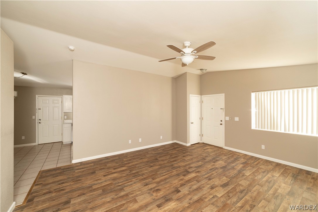 3556 North Willow Road Kingman, AZ 86409 - Photo 11 of 48 a view of a big room with wooden floor and a ceiling fan