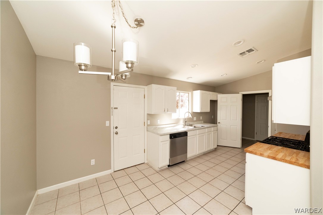 3556 North Willow Road Kingman, AZ 86409 - Photo 12 of 48 a kitchen with a sink cabinets and stainless steel appliances