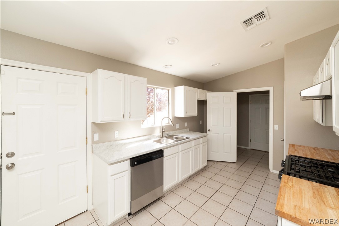 3556 North Willow Road Kingman, AZ 86409 - Photo 14 of 48 a kitchen with a sink stove and cabinets