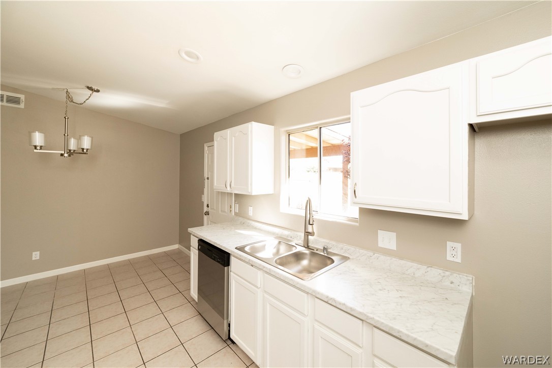 3556 North Willow Road Kingman, AZ 86409 - Photo 15 of 48 a kitchen with a sink cabinets and window