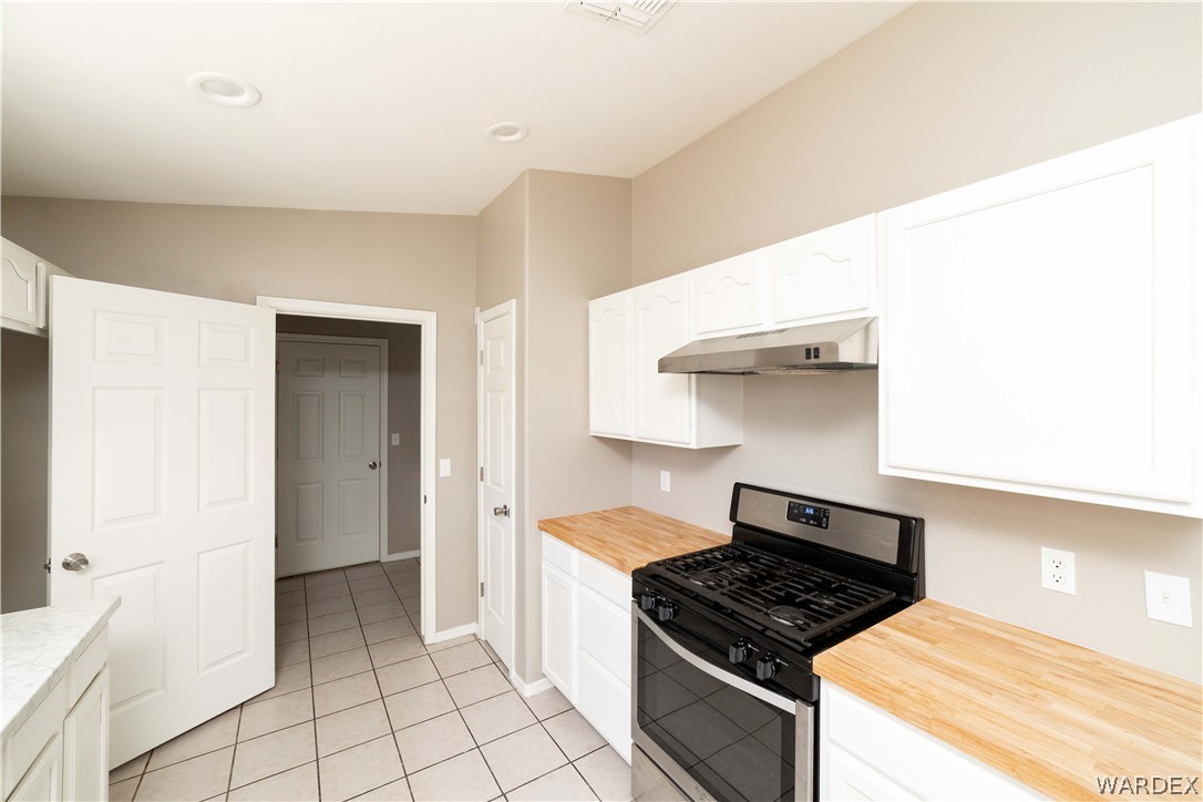 3556 North Willow Road Kingman, AZ 86409 - Photo 16 of 48 a kitchen with granite countertop a stove and a sink