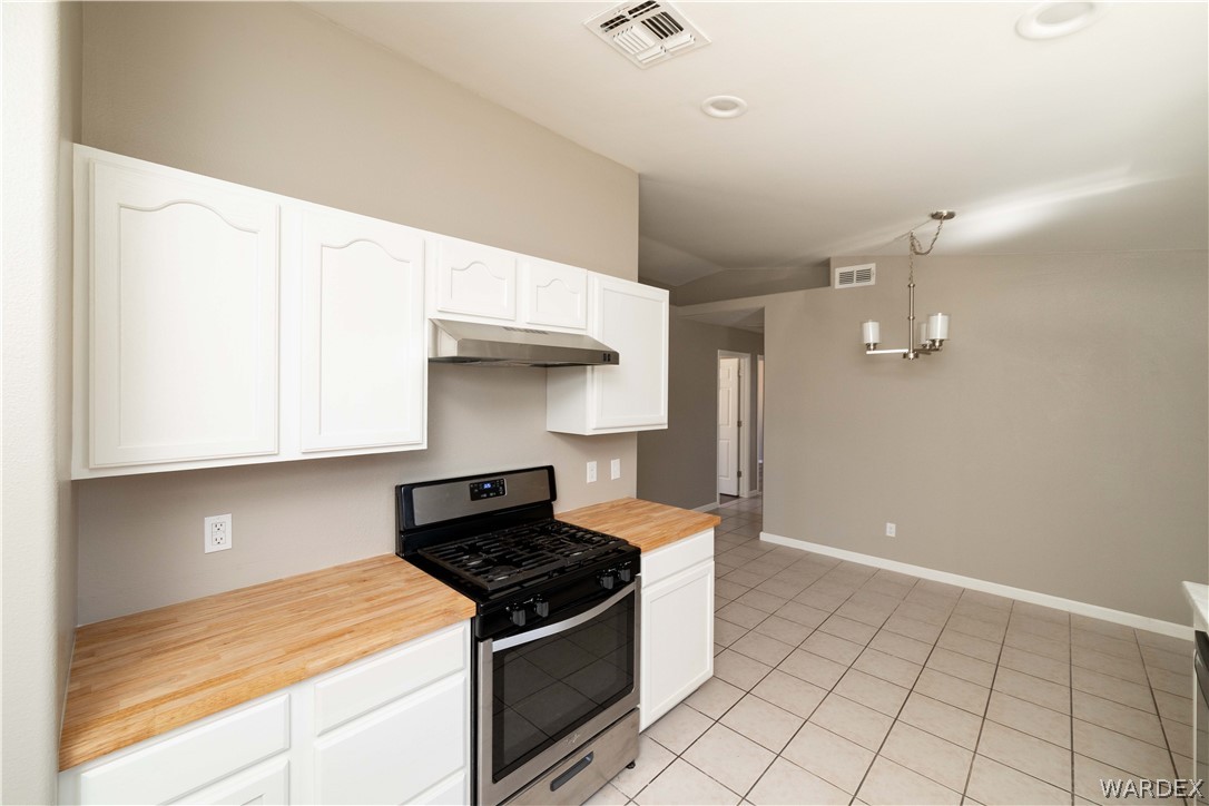 3556 North Willow Road Kingman, AZ 86409 - Photo 17 of 48 a kitchen with stainless steel appliances granite countertop a sink and a stove