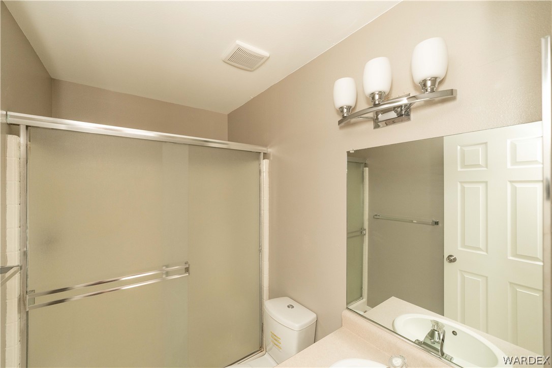 3556 North Willow Road Kingman, AZ 86409 - Photo 20 of 48 a bathroom with a sink mirror vanity and toilet