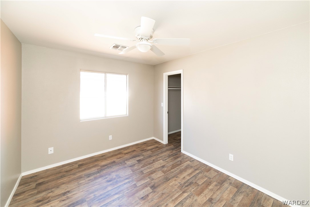 3556 North Willow Road Kingman, AZ 86409 - Photo 24 of 48 an empty room with wooden floor and windows