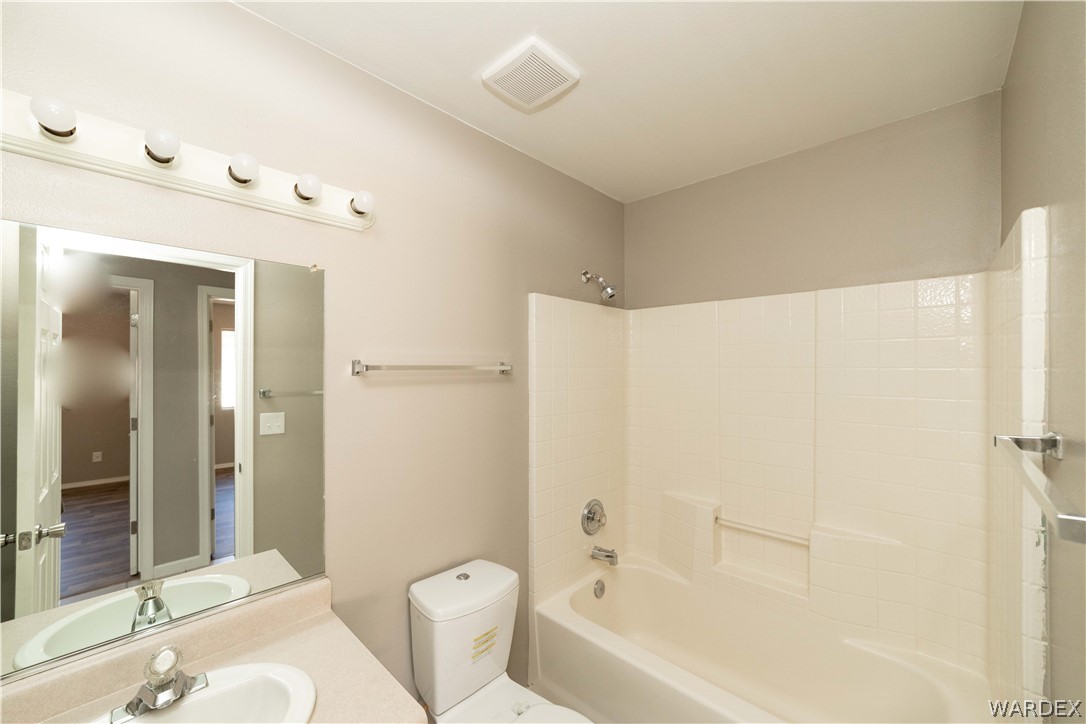 3556 North Willow Road Kingman, AZ 86409 - Photo 28 of 48 a bathroom with a bathtub shower sink vanity and toilet