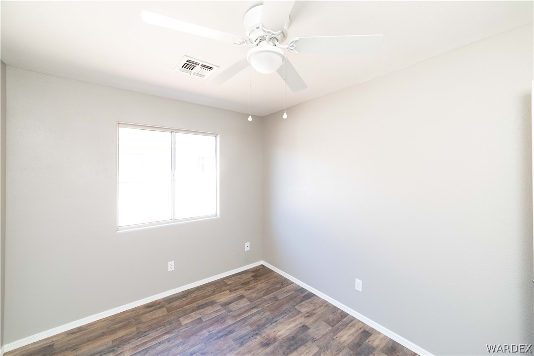 3556 North Willow Road Kingman, AZ 86409 - Photo 30 of 48 an empty room with a window and a fan