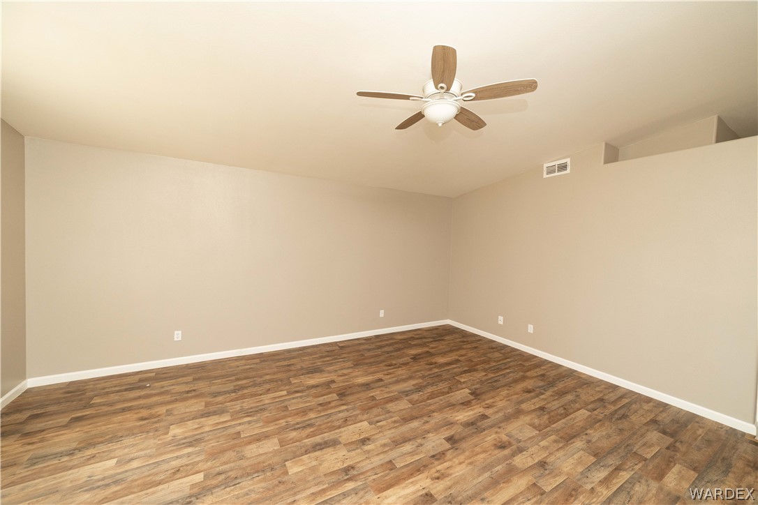 3556 North Willow Road Kingman, AZ 86409 - Photo 10 of 48 a view of a room with wooden floor and ceiling fan