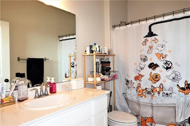 a bathroom with a sink toilet and shower