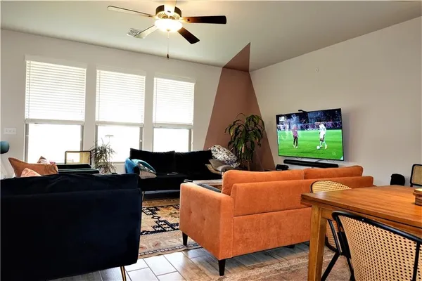 a living room with furniture and a flat screen tv