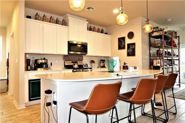 a kitchen with stainless steel appliances granite countertop a sink a stove and a refrigerator
