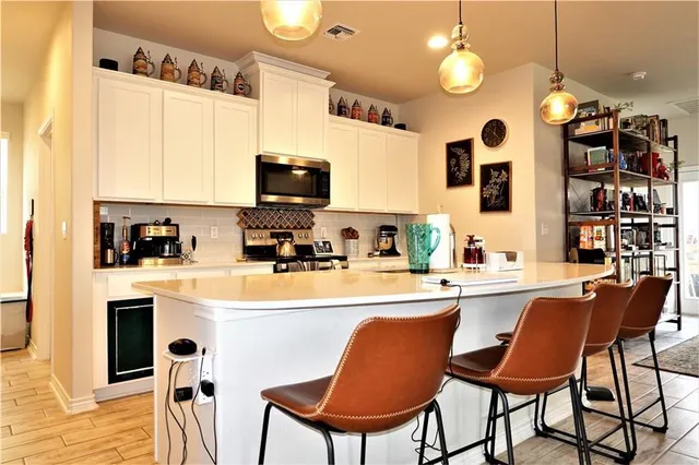 a kitchen with stainless steel appliances granite countertop a sink a stove and a refrigerator