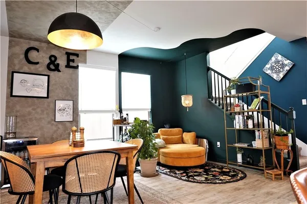 a living room with furniture and a chandelier