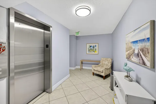 a view of a swimming pool with outdoor seating and barbeque oven